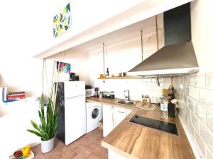 a small kitchen with a sink and a refrigerator at Joy Home Varna in Varna City