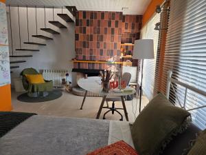 a bedroom with a table and a spiral staircase at B&B Sallent in Sallent