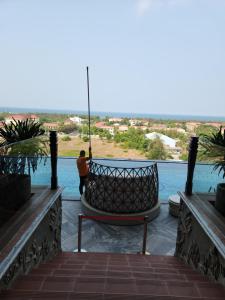 a person standing on a balcony looking out at the water at Yana Apec Phu Yen in Tuy Hoa