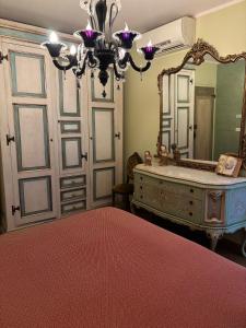 a bedroom with a large mirror and a dresser at Terra e Mare in Santa Maria Pietrafitta +26 photos
