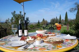 a table with a plate of food and bottles of wine at Terra e Mare in Santa Maria Pietrafitta