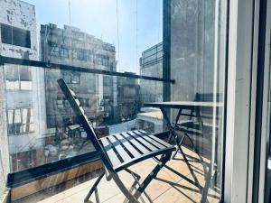 a chair sitting on a balcony with a table at HOTEL SUNIL INN in Raipur