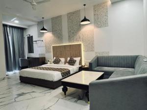 a hotel room with a bed and a couch at HOTEL SUNIL INN in Raipur