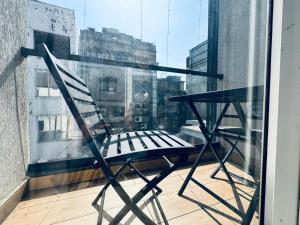 a chair sitting on the ledge of a window at HOTEL SUNIL INN in Raipur +13 photos
