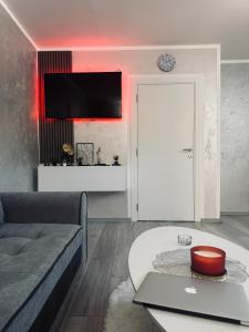 a living room with a couch and a table at Apartman Đak in Foča