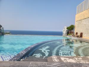 a swimming pool with the ocean in the background at Yana Apec Phu Yen in Tuy Hoa