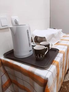 a table with two coffee cups and a blender at Khatuna Home in Tsqaltubo