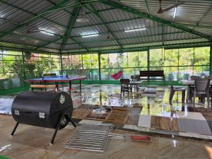 a large tent with a table and chairs and tables at UDUPI HOMESTAY Garden Villa in Udupi