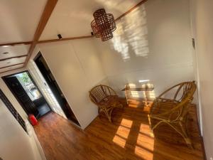 an empty room with two chairs and a table at Elagance Premium Houseboats in Alleppey