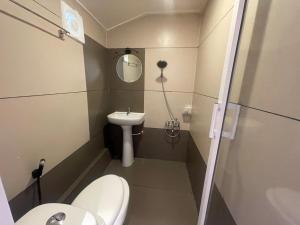 a small bathroom with a toilet and a sink at Elagance Premium Houseboats in Alleppey