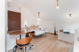 a bedroom with a bed and a table and chairs at ATICO El TRANCO in Villel