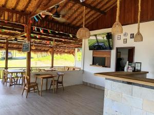 a restaurant with wooden ceilings and tables and chairs at Saluvi Hill's in Pulau Sarang