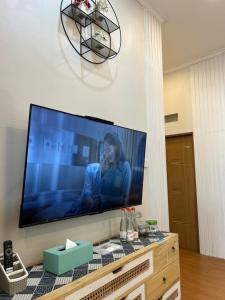 a flat screen tv on a wall in a living room at Clamitan House Padalarang in Padalarang