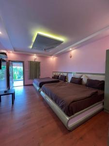a bedroom with a large bed and a television at Mountain Peak Resort in Hassan