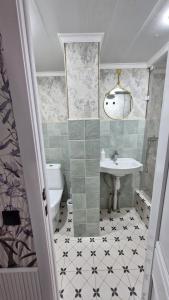 a bathroom with a sink and a toilet at Hostel CAPS HOME boutique in Astana