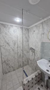 a bathroom with a shower and a sink at Hostel CAPS HOME boutique in Astana
