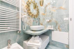 a bathroom with a sink and a mirror and a sink at Suite Acquamarine by Symphonya Luxury Holiday Rentals in Gallipoli
