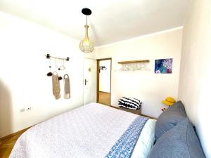a bedroom with a bed and a pendant at Joy Home Varna in Varna City