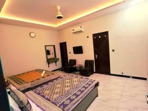 a bedroom with a bed and a tv in it at Galaxy Inn Guest House in Karachi