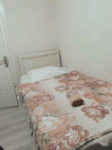 a bedroom with a bed with a flowered blanket at Khatuna Home in Tsqaltubo +8 photos