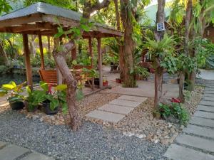 a garden with a gazebo and some plants at REKWOOD Hotel in Boracay