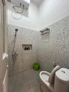 a bathroom with a shower and a toilet in it at Clamitan House Padalarang in Padalarang +34 photos