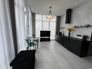 a living room with a kitchen and a dining room at Delmar Apartment Center in Dnipro