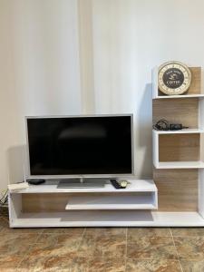 a flat screen tv sitting on a white entertainment center at aldo apartments in Shëngjin