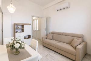 a living room with a couch and a table at Frontemare Apartment by Symphonya Luxury Holiday Rentals in Gallipoli