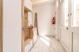 a hallway with a refrigerator and a window at Frontemare Apartment by Symphonya Luxury Holiday Rentals in Gallipoli