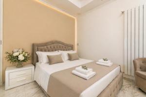 a bedroom with a bed with two towels on it at Frontemare Apartment by Symphonya Luxury Holiday Rentals in Gallipoli
