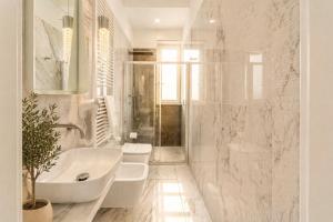 a bathroom with two toilets and a sink and a tub at Frontemare Apartment by Symphonya Luxury Holiday Rentals in Gallipoli +12 photos