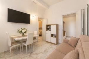 a living room with a couch and a dining room at Frontemare Apartment by Symphonya Luxury Holiday Rentals in Gallipoli