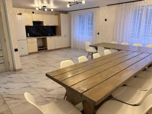 a conference room with a wooden table and white chairs at Trostjn house in Slavske