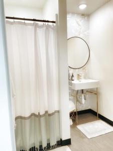 a bathroom with a shower curtain and a sink at The Shack Inn in Homer +23 photos