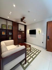 a living room with a couch and a tv at Magnolia Boutique Hue in Thôn Trường Giang +20 photos