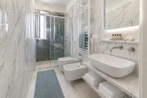 a white bathroom with a sink and a toilet at White Loft by Symphonya Luxury Holiday Rentals in Gallipoli +7 photos