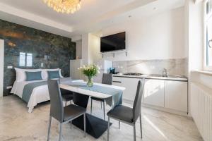 a kitchen and a bedroom with a bed and a table at White Loft by Symphonya Luxury Holiday Rentals in Gallipoli