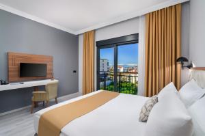a hotel room with a bed and a window at Arya inn suit in Serik +21 photos