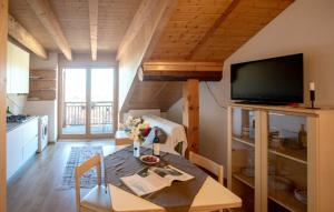 a living room with a table and a television at ANESI appartamenti in Baselga di Pinè