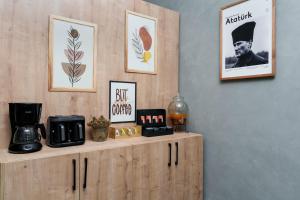 a wooden cabinet with a coffee maker on top of it at Arya inn suit in Serik