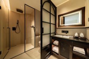 a bathroom with a shower and a sink and a mirror at Chengdu Yunduo 云朵Hotel in Chengdu +103 photos