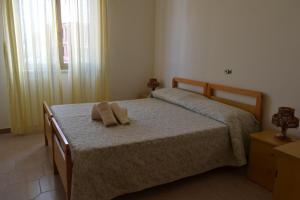 a bedroom with a bed with two towels on it at Appartamenti Onde Blu in Le Castella