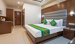 a bedroom with a large bed in a room at Treebo Premium Grand Legacy Elite with Roof Top Cafe in Dehradun +40 photos