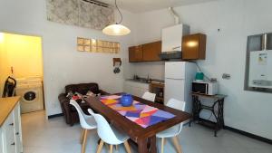 a kitchen with a wooden table and a dining room at Casa Elsa in Corniglia