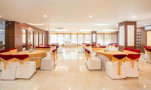 a restaurant with tables and chairs in a room at Treebo Premium Grand Legacy Elite with Roof Top Cafe in Dehradun