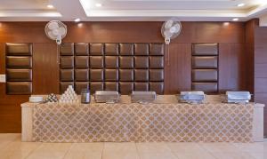 a bar in a hotel room with a counter at Treebo Premium Grand Legacy Elite with Roof Top Cafe in Dehradun