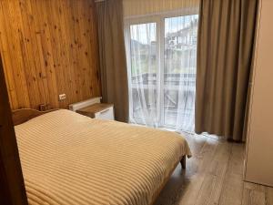 a bedroom with a bed and a large window at Trostjn house in Slavske +118 photos