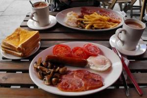 a table with two plates of breakfast foods and coffee at In Vino Veritas B&B in Arcola +17 photos