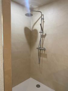 a shower stall with a glass door with a shadow at La Finca in Nîmes +5 photos